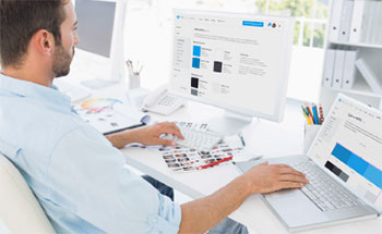 Worker using computer with colour swatches on screen