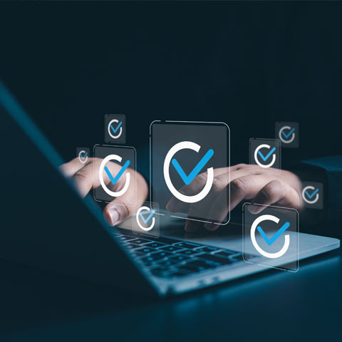 The 5 Steps to ABM Success Business person in a darkened stylised room, with hand on laptop, surrounded by icons of a tick