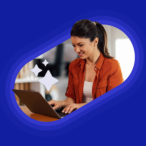 Happy looking businesswoman sat at laptop, surrounded by stars