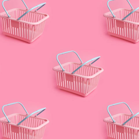 Transforming Content Operations for Retail Brands Graphic; Pink shopping baskets on a pink background