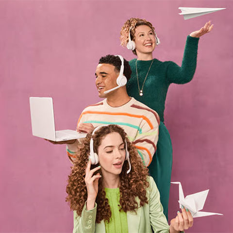 3 Customer Service Workers, posed in an unlikely way, wearing telephone headsets, holding oragami shapes